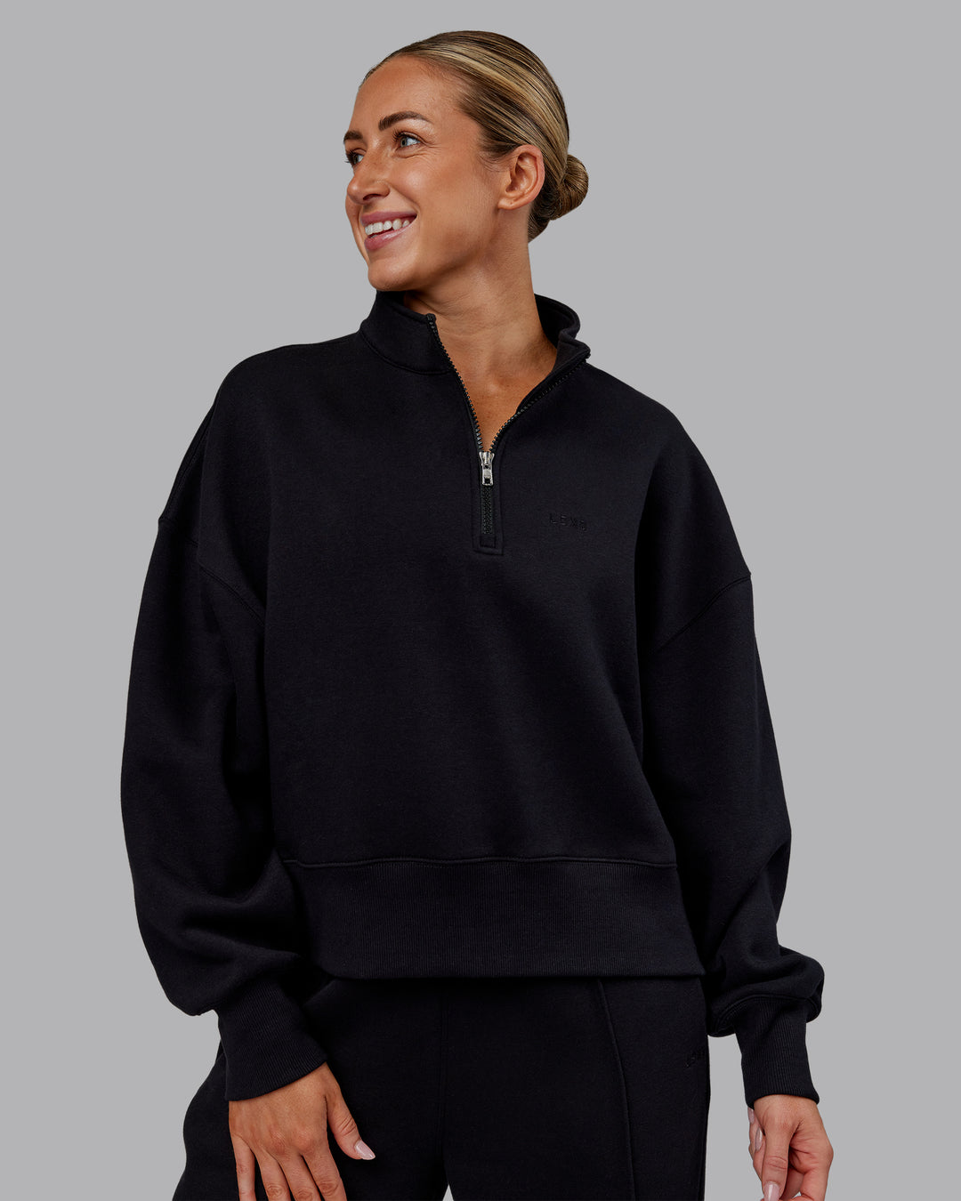Woman wearing MVP 1/2 Zip Oversized Sweater - Black | Model:Paris | Size:S - view 1
