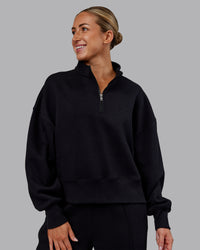 Woman wearing MVP 1/2 Zip Oversized Sweater - Black | Model:Paris | Size:S | Thumbnail Index: 0