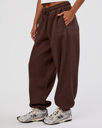 Woman wearing MVP Oversized Slouchy Fit Track Pant - Hot Chocolate | Model:Brylee | Size:S | Thumbnail Index: 0