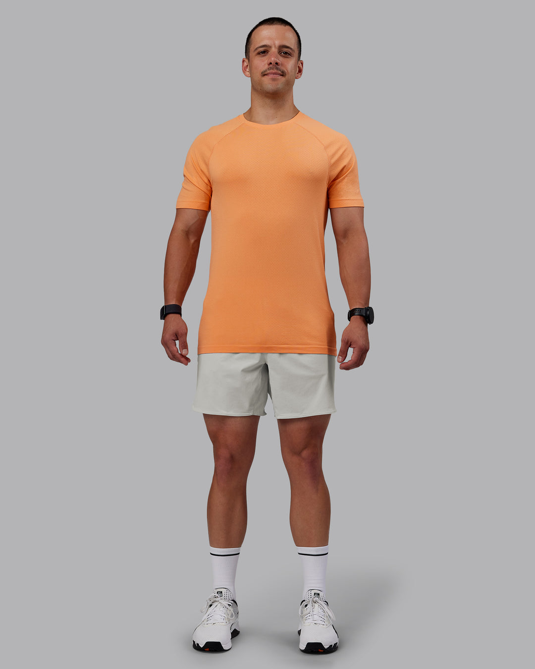 Man wearing AeroFLX+ Seamless Tee - Cantaloupe/Cantaloupe Marl - view 5