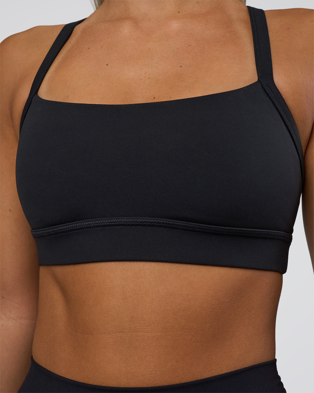 Woman wearing Momentum Sports Bra - Black | Model:Amity | Size:S - view 4