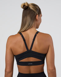Woman wearing Momentum Sports Bra - Black | Model:Amity | Size:S | Thumbnail Index: 1