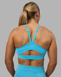 Woman wearing Momentum Sports Bra - Blue Atoll | Model:Georgia | Size:S | Thumbnail Index: 6