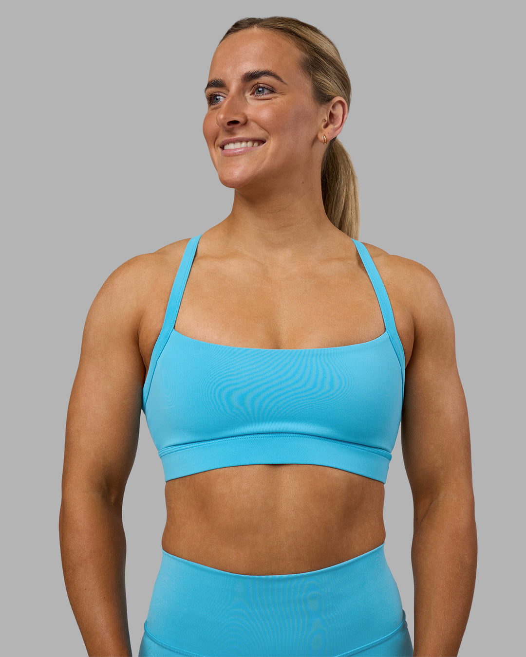 Woman wearing Momentum Sports Bra - Blue Atoll | Model:Georgia | Size:S - view 2