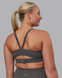 Woman wearing Momentum Sports Bra D/DD/E - Dark Storm | Model:Lilli | Size:S | Thumbnail Index: 1