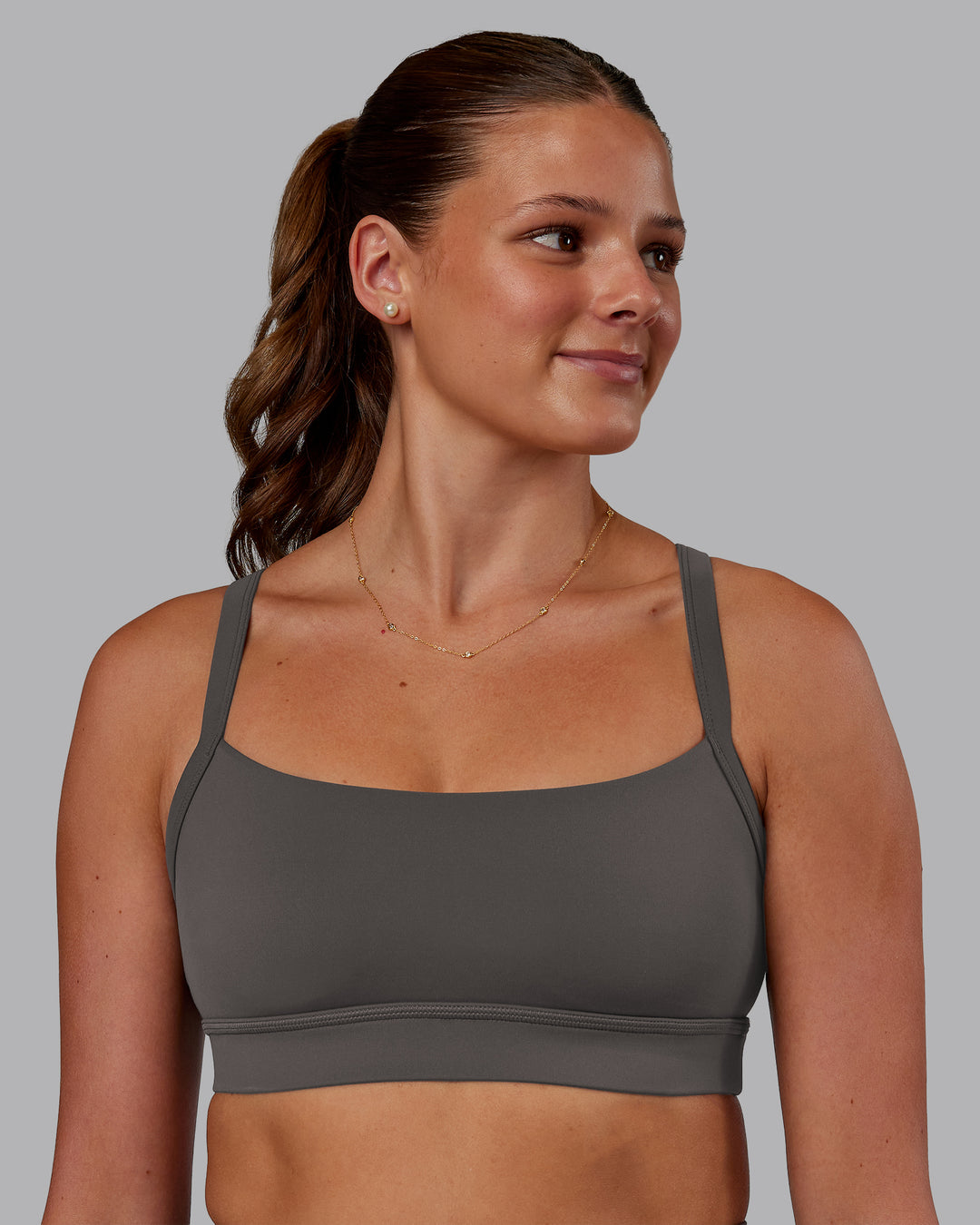 Woman wearing Momentum Sports Bra - Dark Storm | Model:Phoebe | Size:S - view 1