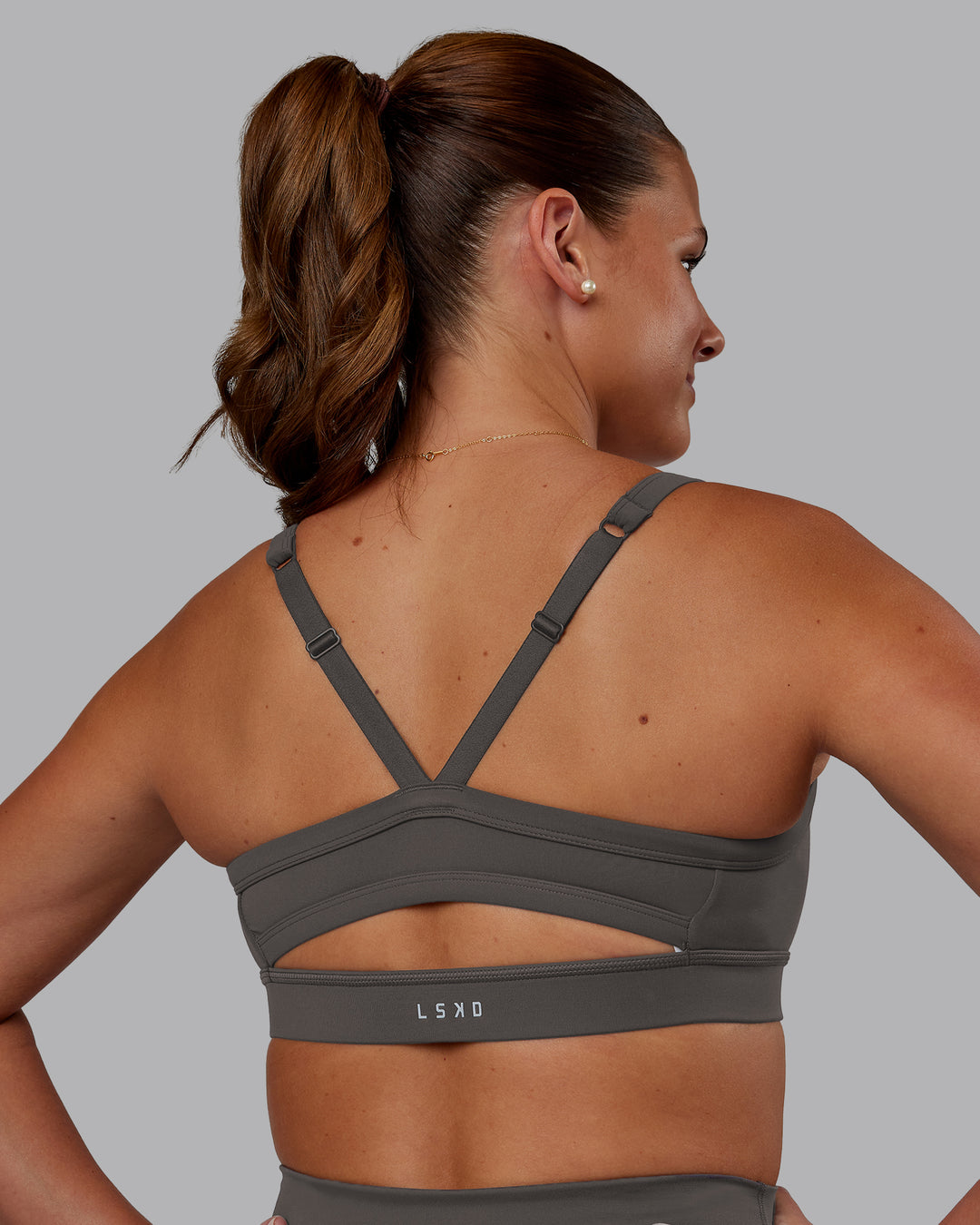 Woman wearing Momentum Sports Bra - Dark Storm | Model:Phoebe | Size:S - view 2