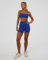 Woman wearing Momentum Sports Bra - Electric Indigo | Model:Amity | Size:S | Thumbnail Index: 2