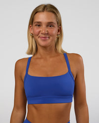 Woman wearing Momentum Sports Bra - Electric Indigo | Model:Amity | Size:S | Thumbnail Index: 0