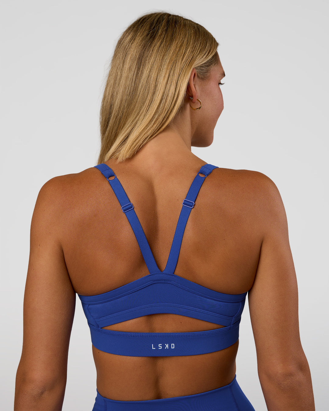 Woman wearing Momentum Sports Bra - Electric Indigo | Model:Amity | Size:S - view 2
