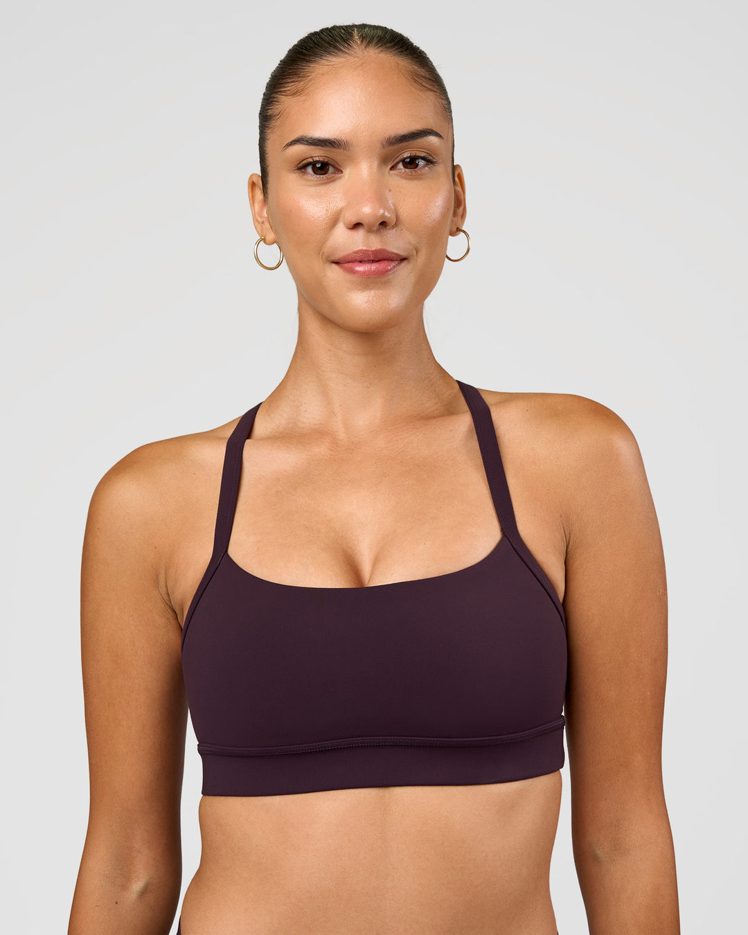 Woman wearing Momentum Sports Bra - Midnight Plum | Model:Rhiley | Size:S - view 1