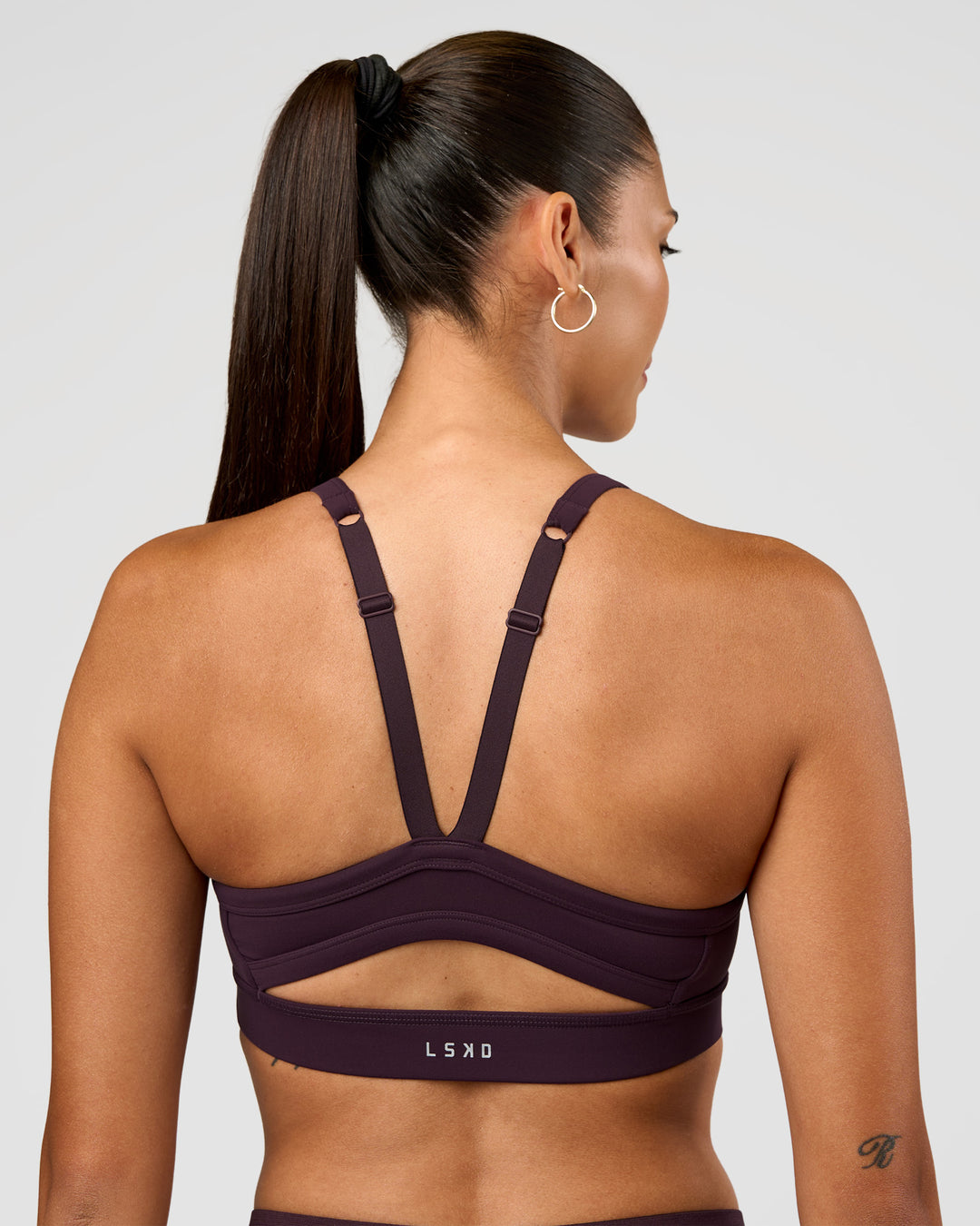 Woman wearing Momentum Sports Bra - Midnight Plum | Model:Rhiley | Size:S - view 6