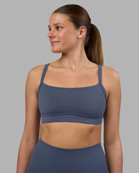 Woman wearing Momentum Sports Bra - Night Shadow | Model:Phoebe | Size:S | Thumbnail Index: 0