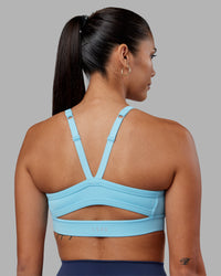 Woman wearing Momentum Sports Bra - Sky Blue | Model:Rhiley | Size:S | Thumbnail Index: 1