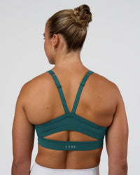 Woman wearing Momentum Sports Bra - Transformative Teal | Model:Sav | Size:S | Thumbnail Index: 0