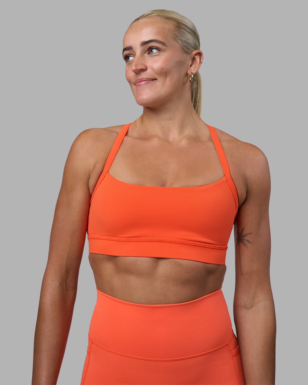 Woman wearing Momentum Sports Bra - Ultra Orange | Model:Katie | Size:S - view 1