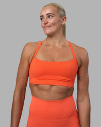 Woman wearing Momentum Sports Bra - Ultra Orange | Model:Katie | Size:S | Thumbnail Index: 0