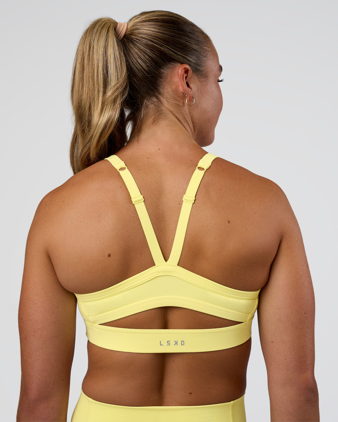 Woman wearing Momentum Sports Bra - Yellow Fizz | Model:Sav | Size:S - view 2
