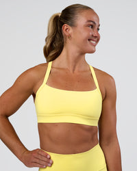 Woman wearing Momentum Sports Bra - Yellow Fizz | Model:Sav | Size:S | Thumbnail Index: 2