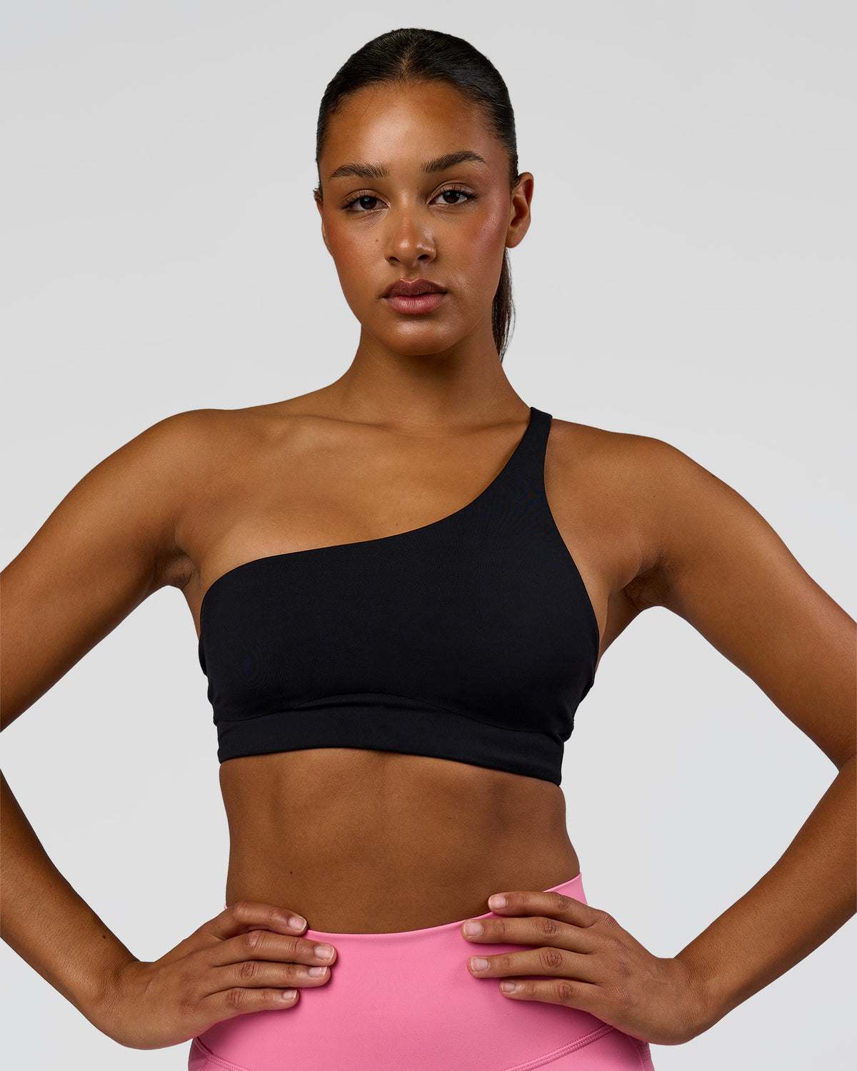 Woman wearing Muse Asymmetric Sports bra - Black | Model:Rosie | Size:S