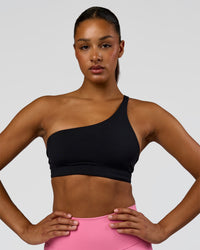 Woman wearing Muse Asymmetric Sports bra - Black | Model:Rosie | Size:S | Thumbnail Index: 0