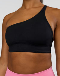 Woman wearing Muse Asymmetric Sports bra - Black | Model:Rosie | Size:S | Thumbnail Index: 2