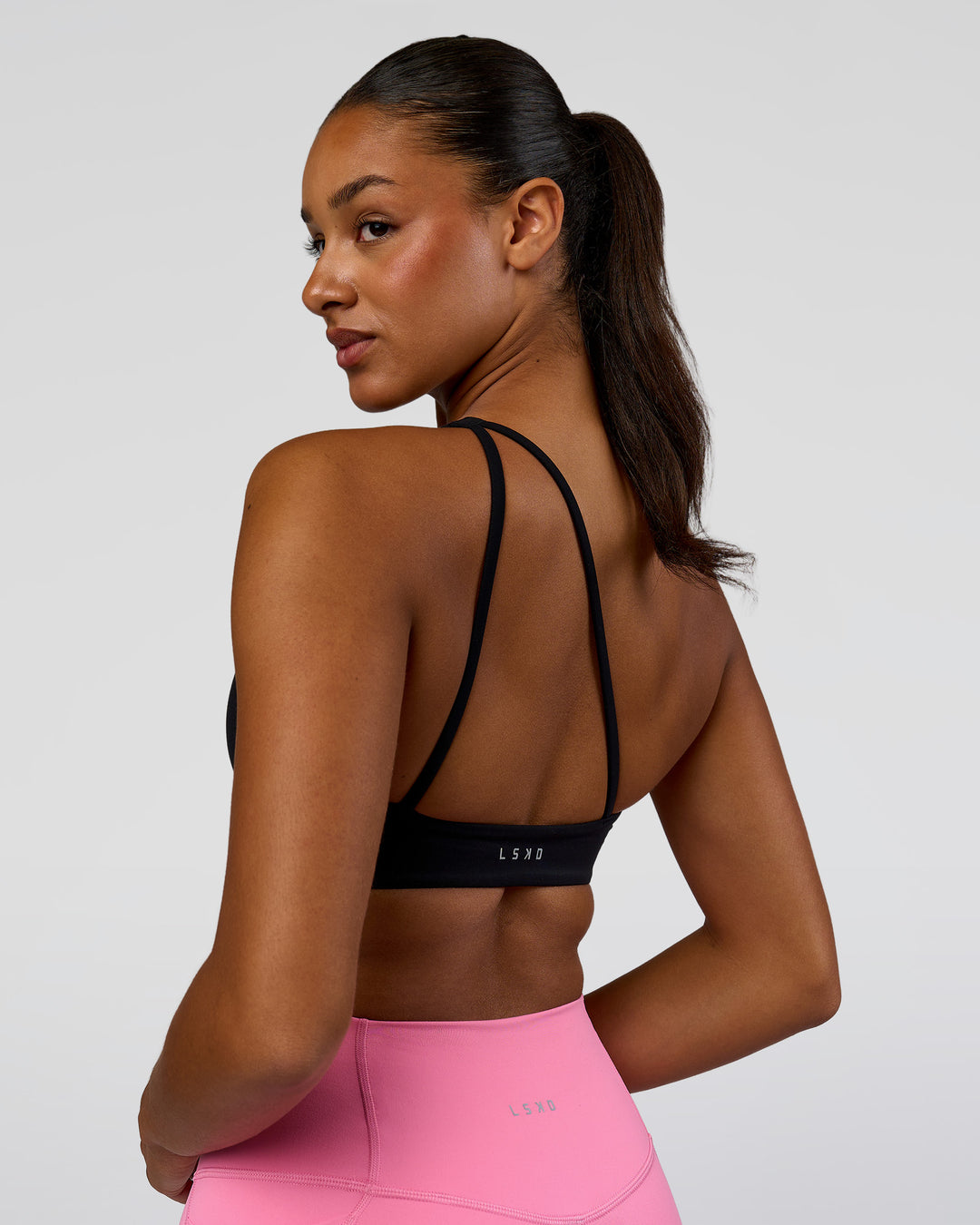 Woman wearing Muse Asymmetric Sports bra - Black | Model:Rosie | Size:S - view 7