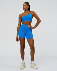 Woman wearing Muse Asymmetric Sports bra - Palace Blue | Model:Rosie | Size:S | Thumbnail Index: 2