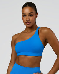 Woman wearing Muse Asymmetric Sports bra - Palace Blue | Model:Rosie | Size:S | Thumbnail Index: 4