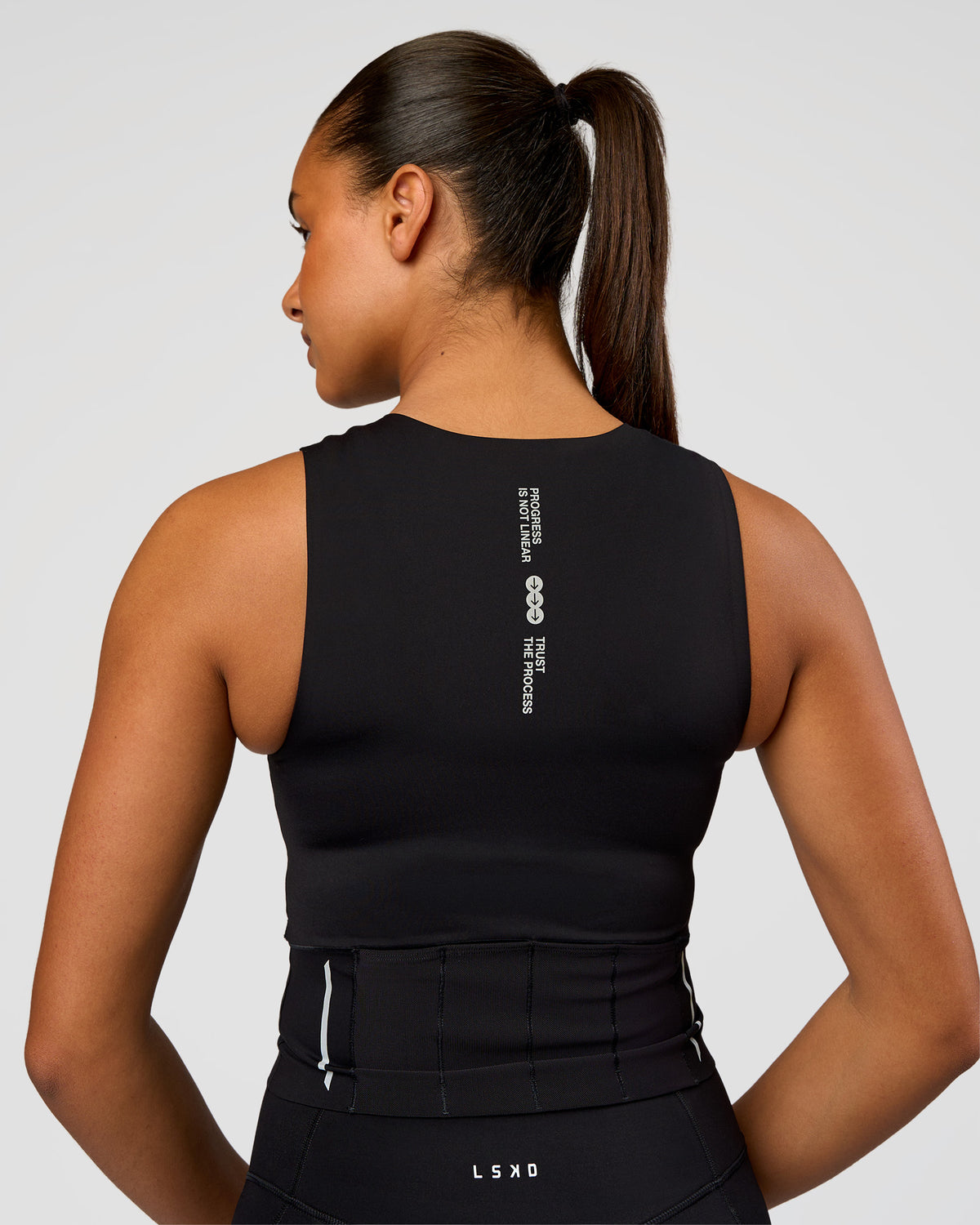 Woman wearing NyxRun Stash Tank - Black | Model:Rosie | Size:S
