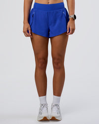 Woman wearing Pacer 3" Run Short - Electric Indigo | Model:Emelia | Size:S | Thumbnail Index: 2