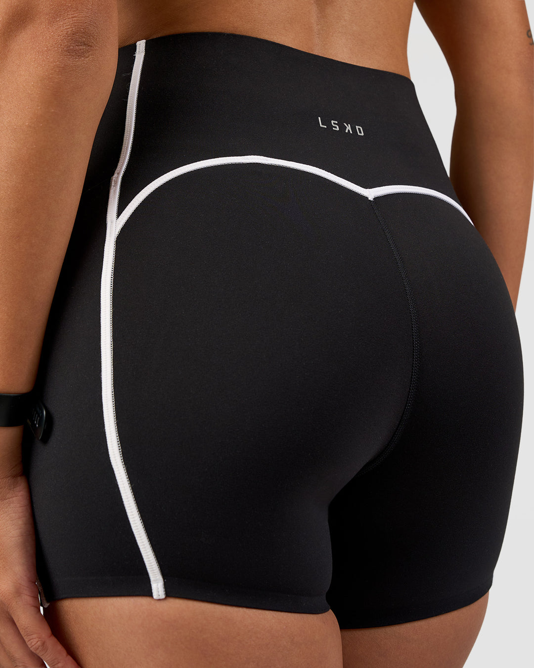 Woman wearing Power Ultra High-Rise 4" Short Pockets - Black | Model:Rhiley | Size:S - view 3