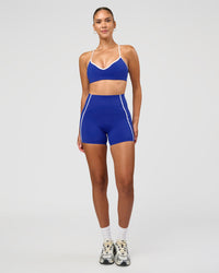 Woman wearing Power Ultra High-Rise 4" Short Pockets - Electric Indigo | Model:Rhiley | Size:S | Thumbnail Index: 9