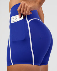 Woman wearing Power Ultra High-Rise 4" Short Pockets - Electric Indigo | Model:Rhiley | Size:S | Thumbnail Index: 4
