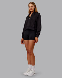 Woman wearing Pursue Mid-Weight Hoodie - Black | Model:Ella | Size:S | Thumbnail Index: 1