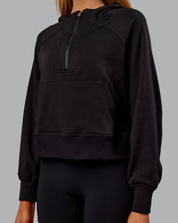 Woman wearing Pursue Mid-Weight Hoodie - Black | Model:Ella | Size:S | Thumbnail Index: 3