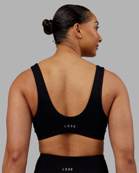 Woman wearing Reform Sports Bra - Black | Model:Ayla | Size:S | Thumbnail Index: 1