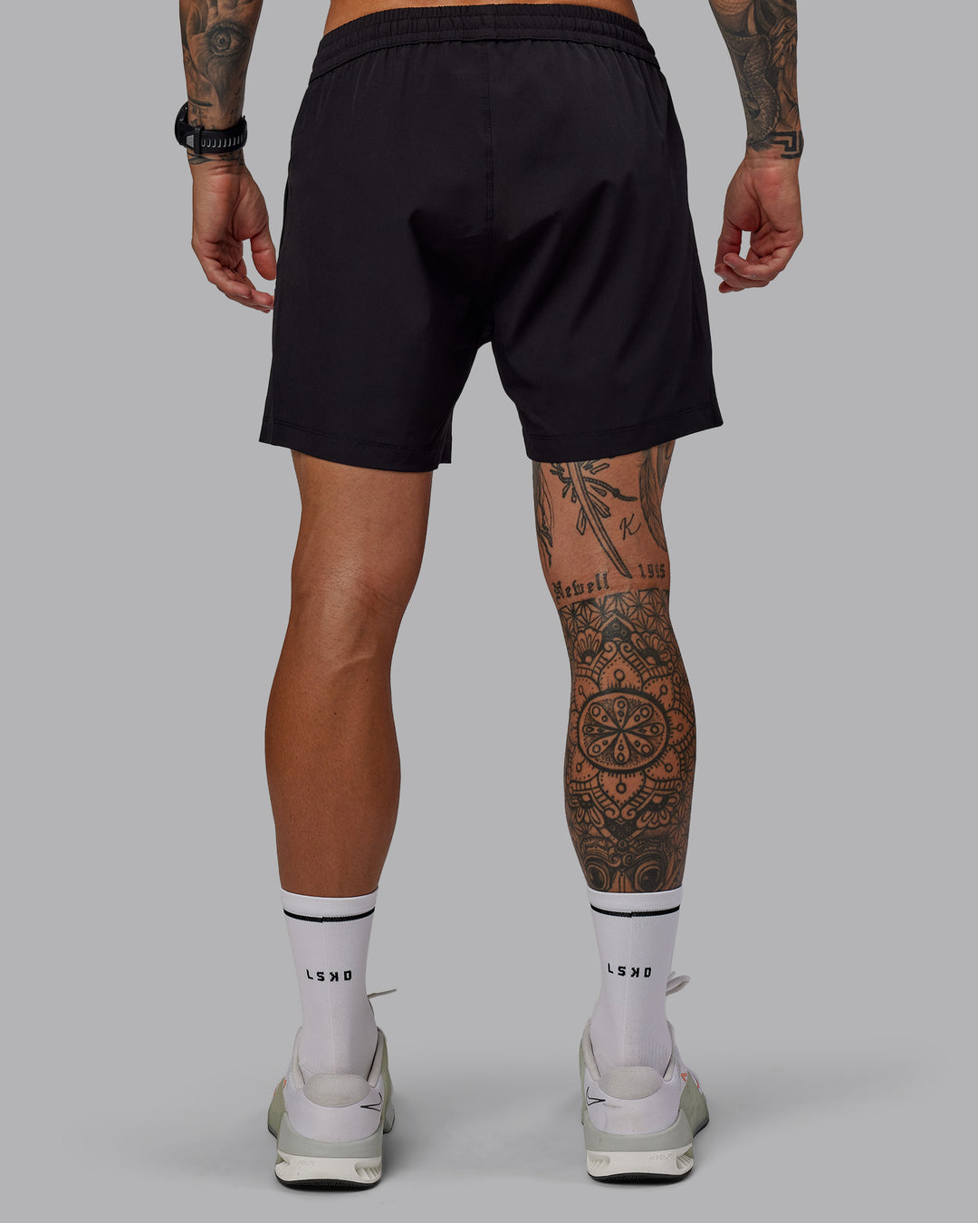 Man wearing Rep 5" Lined Performance Shorts in Black | Size:S - view 4