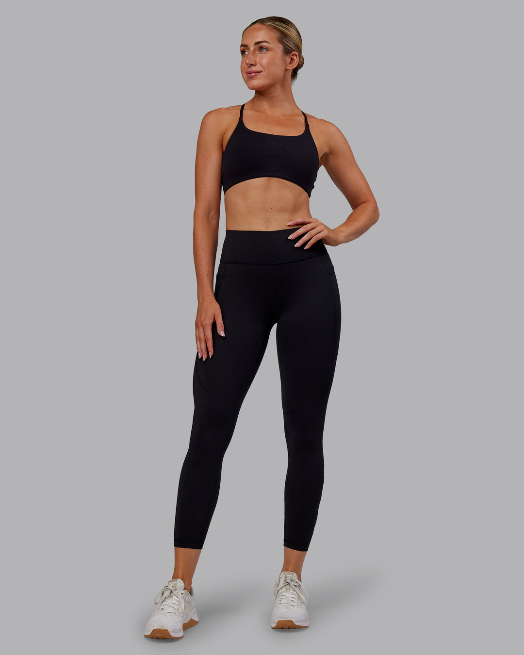 Woman wearing Rep Ultra High-Rise 7/8 Legging Pockets - Black-Retro Blue | Model:Paris | Size:S - view 7