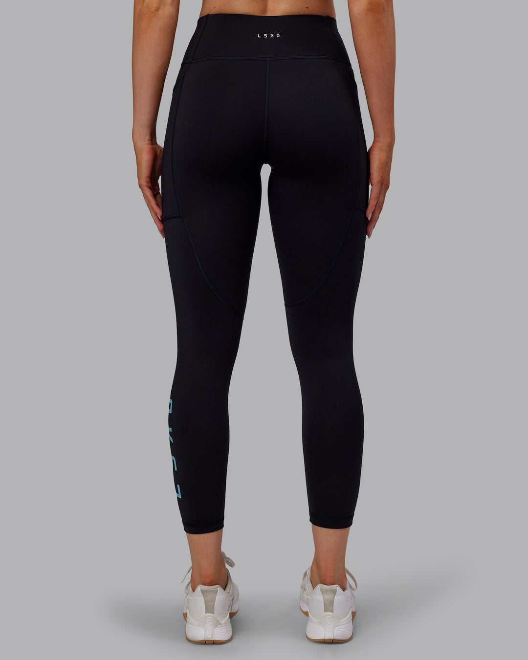 Woman wearing Rep Ultra High-Rise 7/8 Legging Pockets - Black-Retro Blue | Model:Paris | Size:S - view 3