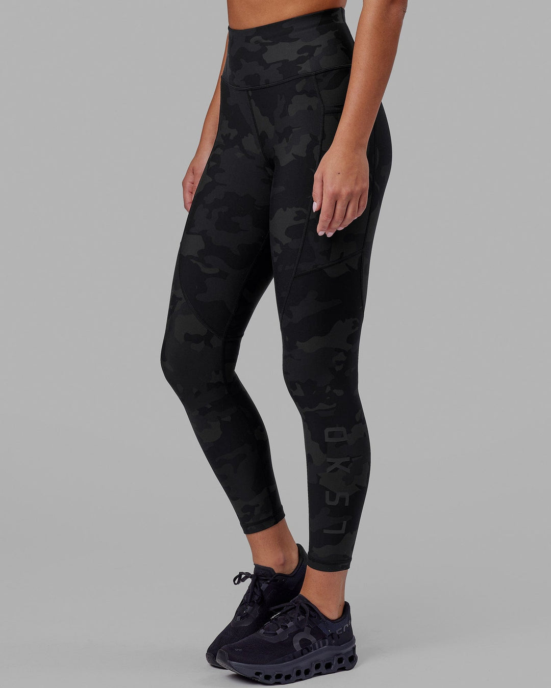 Woman wearing Rep Ultra High-Rise 7/8 Legging Pockets - Black Camo | Model:Milly | Size:S - view 2