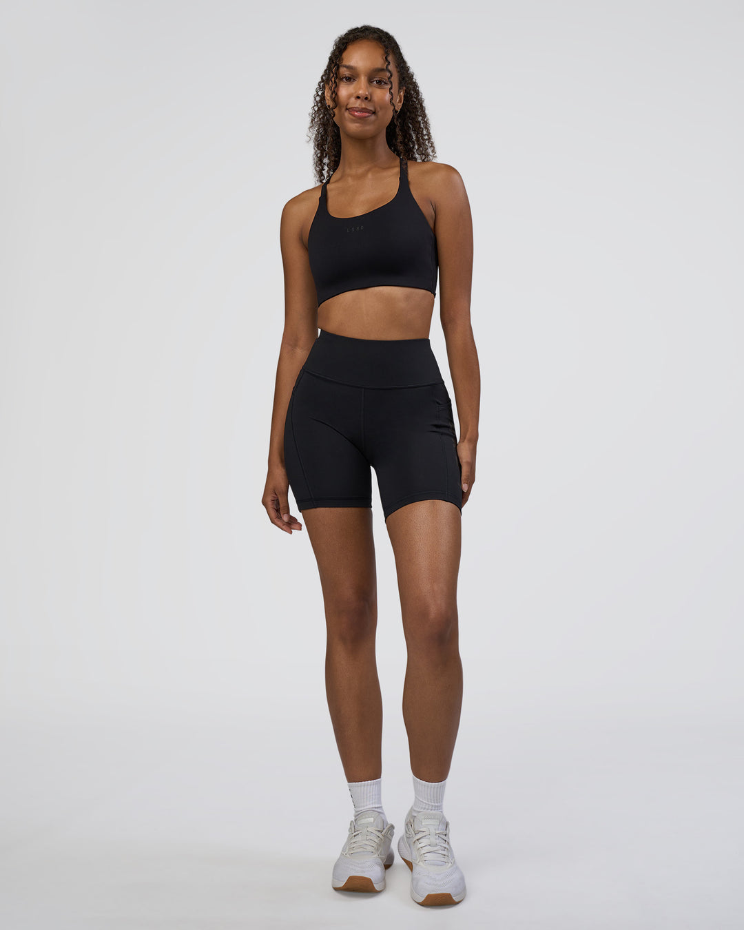 Woman wearing Rep Ultra High-Rise 6" Short Pockets - Black-Black | Model:Jordan | Size:S - view 2