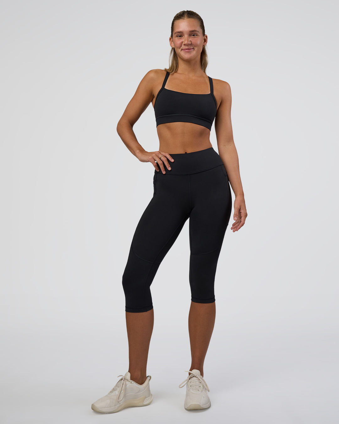 Woman wearing Rep Ultra High-Rise 3/4 Legging Pockets - Black-Black | Model:Amity | Size:S - view 2