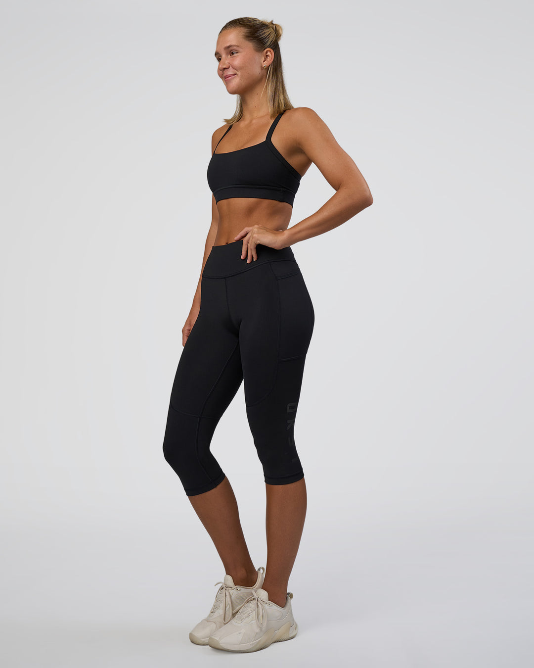Woman wearing Rep Ultra High-Rise 3/4 Legging Pockets - Black-Black | Model:Amity | Size:S - view 5