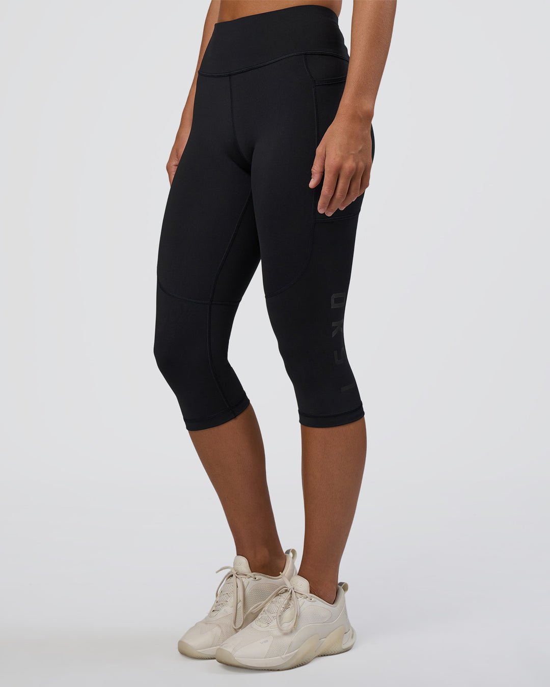 Woman wearing Rep Ultra High-Rise 3/4 Legging Pockets - Black-Black | Model:Amity | Size:S - view 1