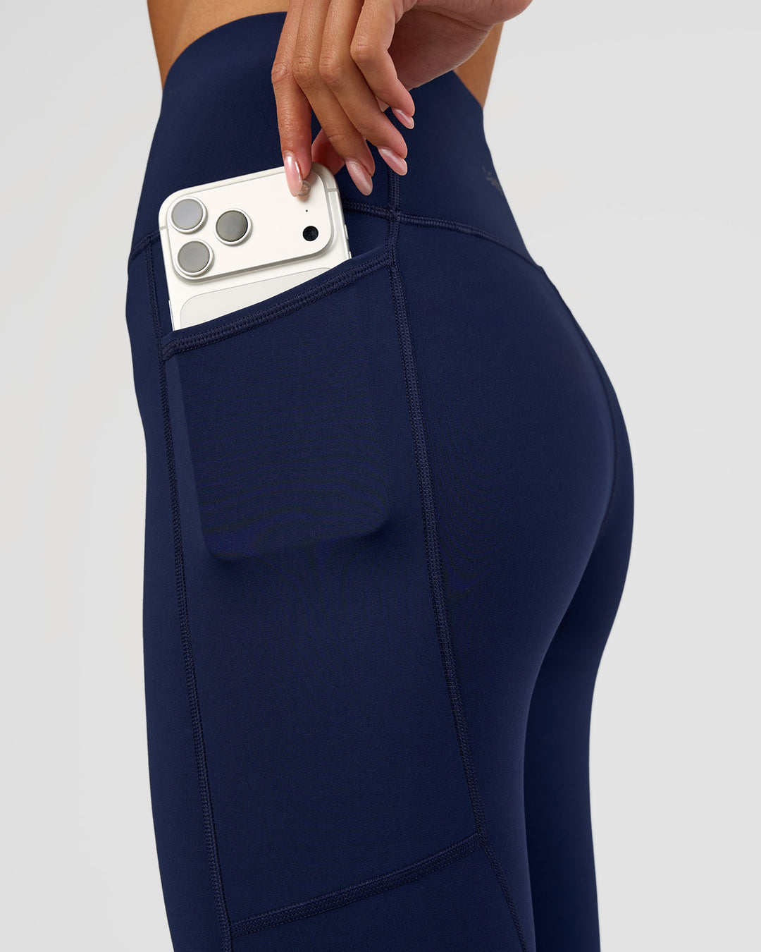 Woman wearing Rep Ultra High-Rise 3/4 Legging Pockets - Future Navy-White | Model:Dakota | Size:S - view 3