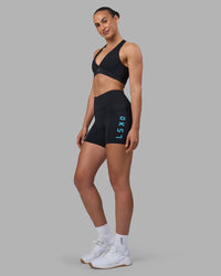 Woman wearing Rep Ultra High-Rise 4" Short Pockets - Black-Blue Atoll | Model:Sophie | Size:S | Thumbnail Index: 1