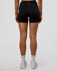 Woman wearing Rep Ultra High-Rise 4" Short Pockets - Black-Electric Indigo | Model:Evie | Size:S | Thumbnail Index: 4