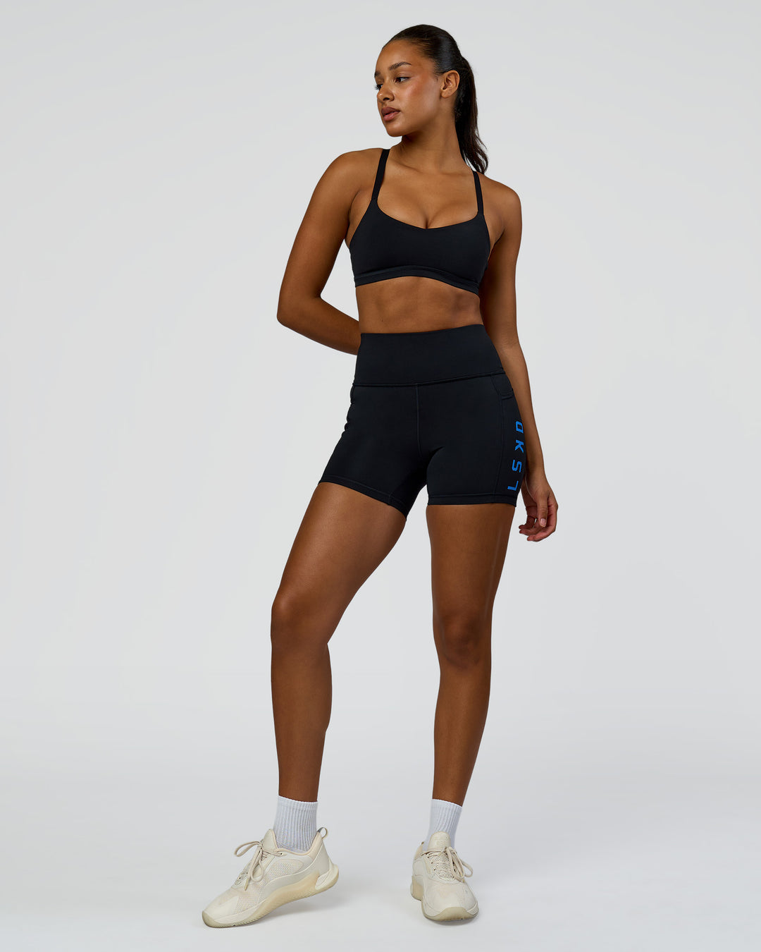 Woman wearing Rep Ultra High-Rise 4" Short Pockets - Black-Palace Blue | Model:Rosie | Size:S - view 3