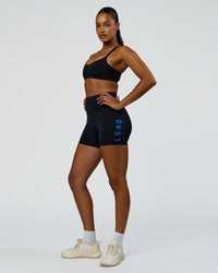 Woman wearing Rep Ultra High-Rise 4" Short Pockets - Black-Palace Blue | Model:Rosie | Size:S | Thumbnail Index: 7